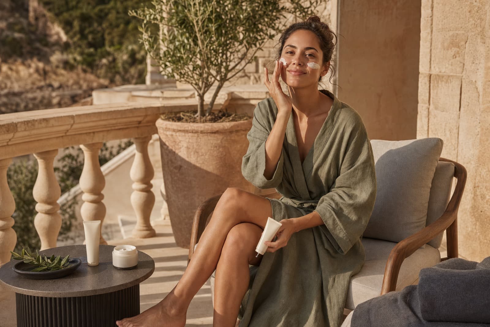 Woman applying Lumière SPF in morning light